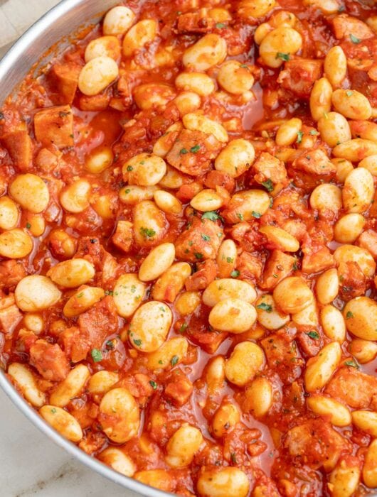 Polish beans and sausage in a frying pan.