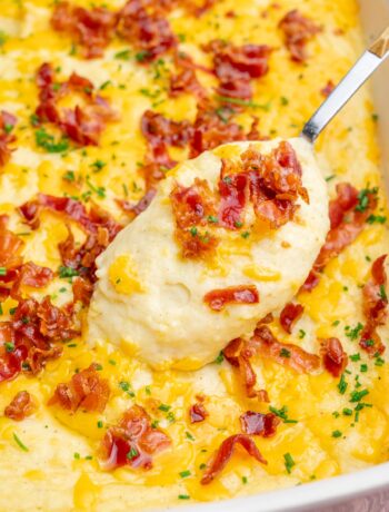 Loaded mashed potato casserole in a white baking dish.