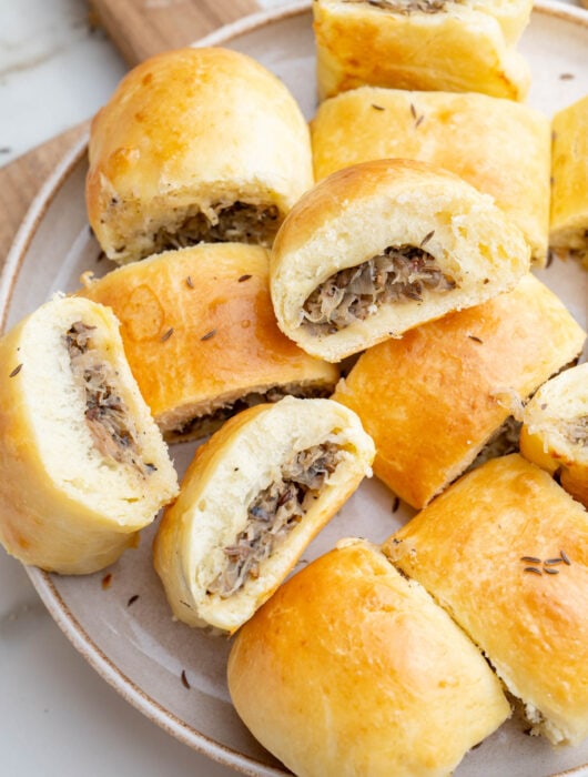 Sauerkraut and mushrooms buns on a plate.