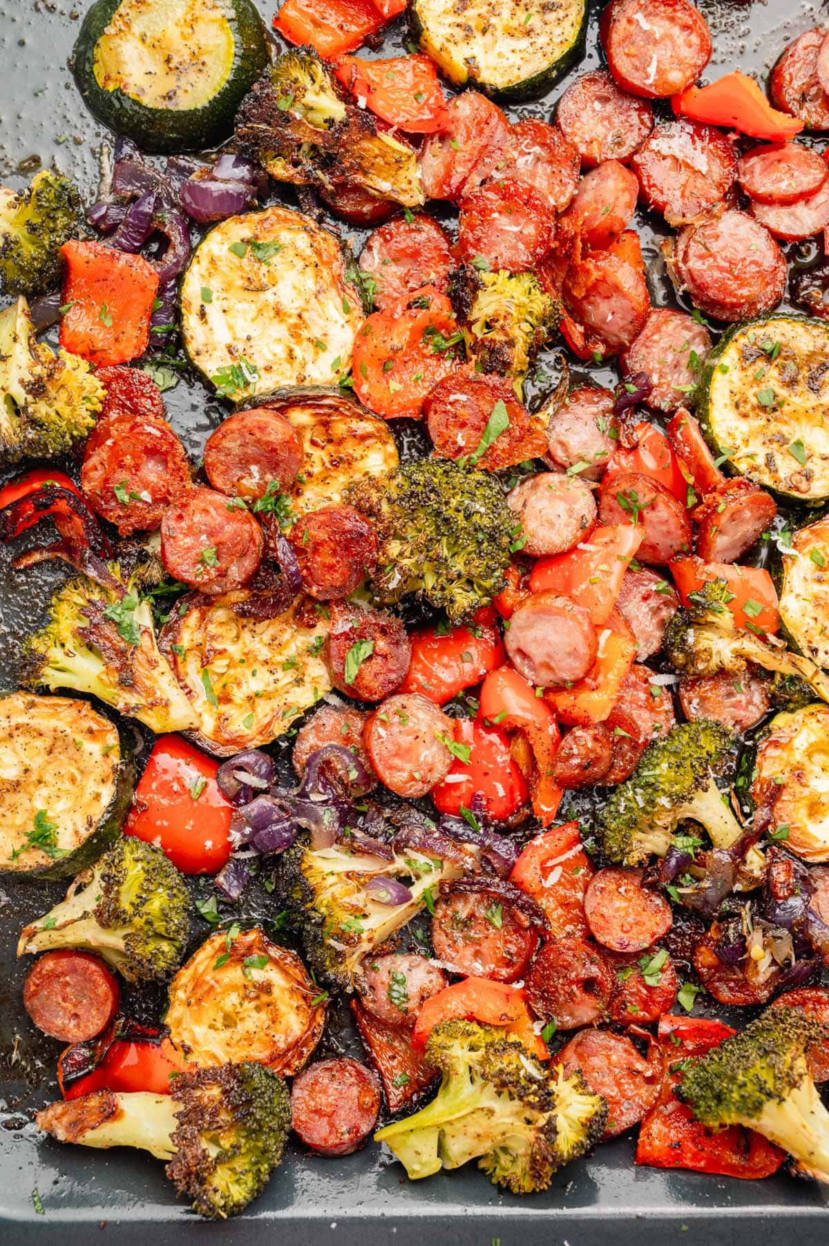 Roasted sausage and vegetables on a sheet pan.