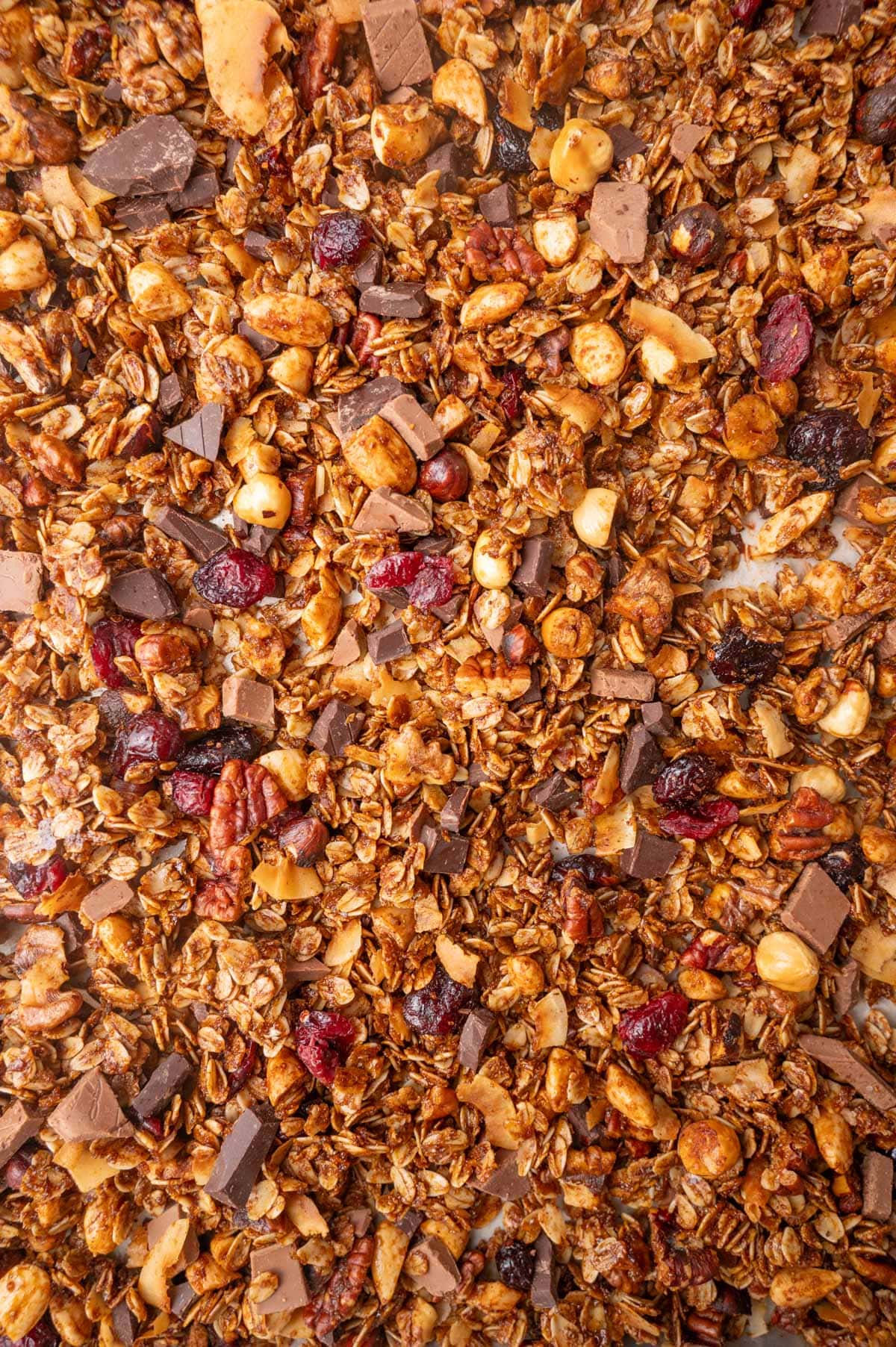A close up photo of gingerbread granola on a baking sheet.