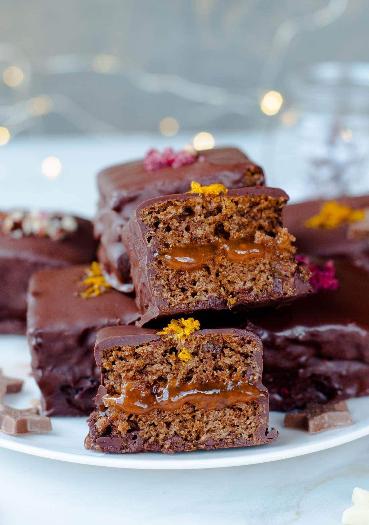 Lebkuchen cookie squares cut in half on a white plate.