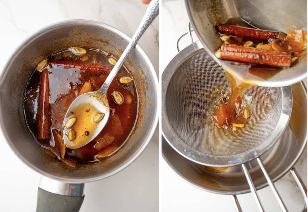 Orange spiced syrup in a pot. Syrup is being strained on a sieve.