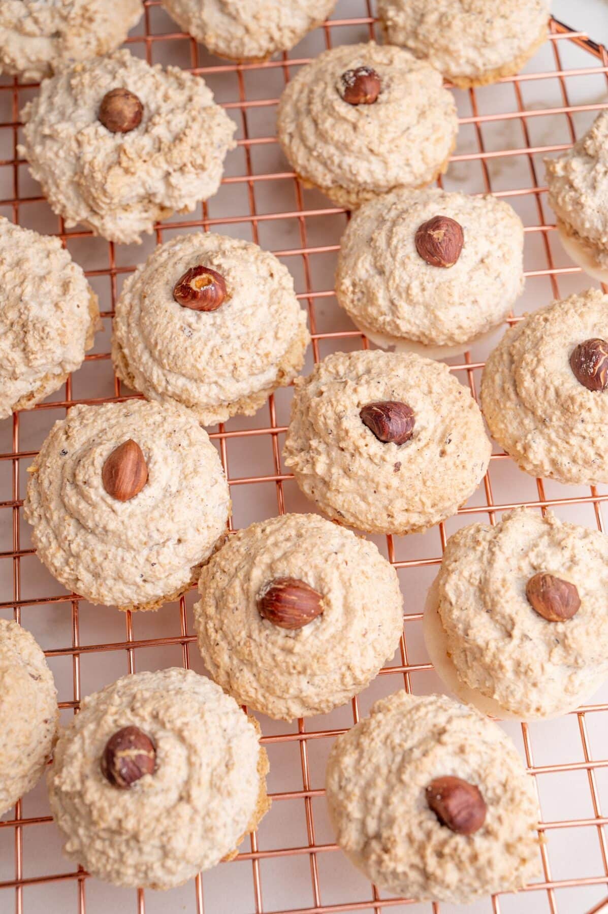 German cookies Nussmakronen on a gold wire rack.