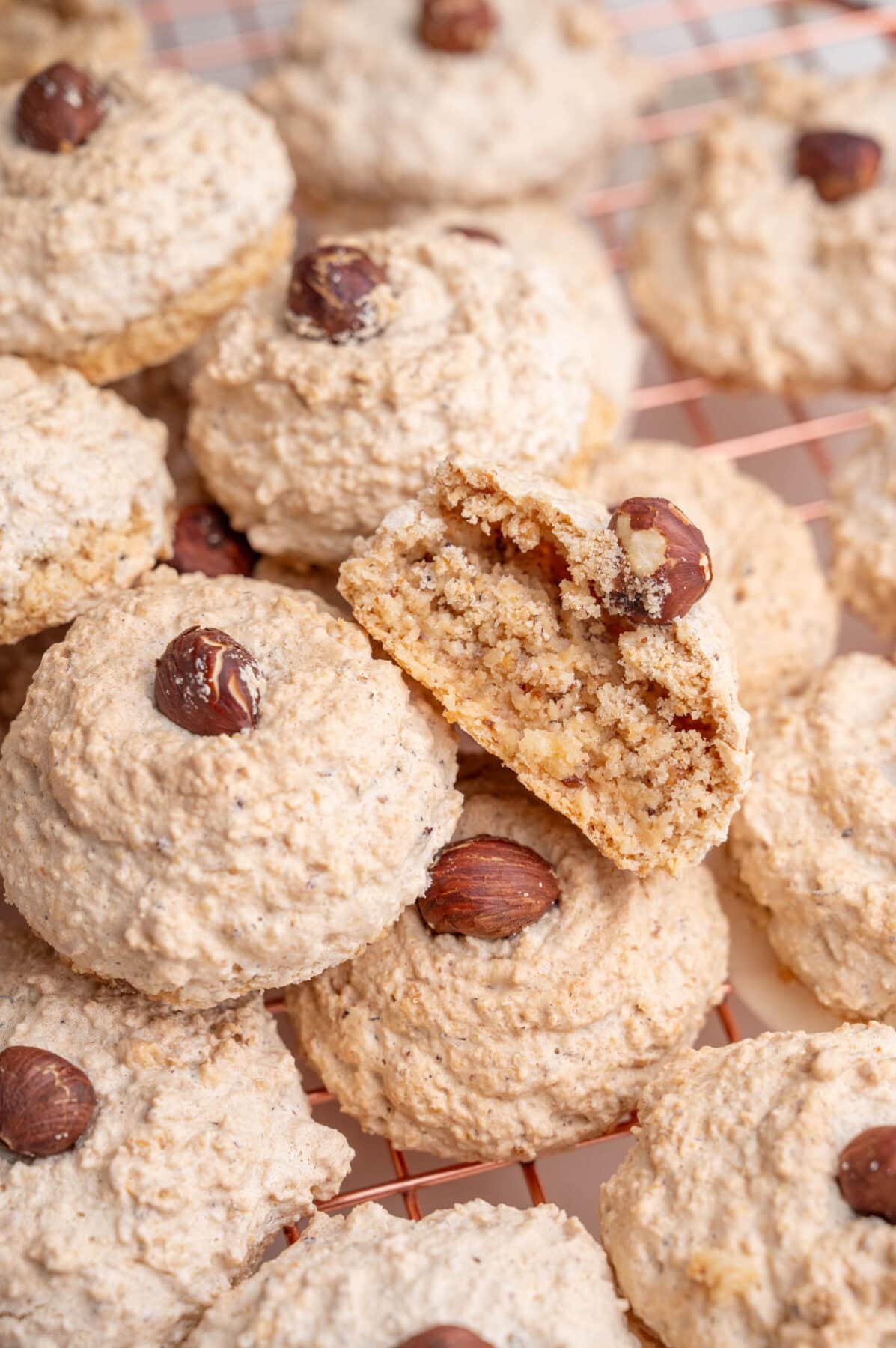 A close up photo of Nussmakronen. One cookie is cut in half.