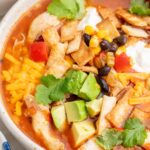 Chicken tortilla soup in a white bowl.