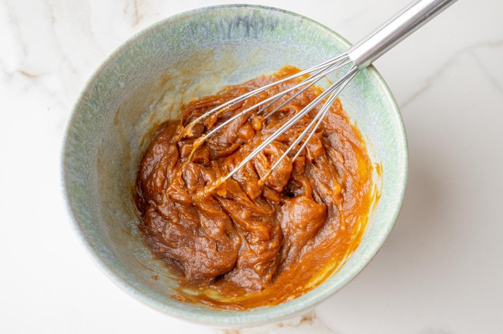 Molasses, maple syrup, and coconut oil in a bowl.