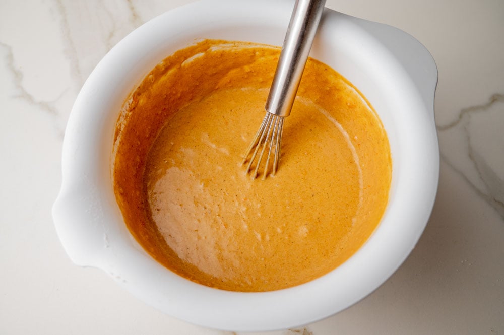 Gingerbread pancakes batter in a white bowl.