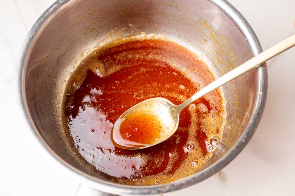 Orange gingerbread syrup in a pot.