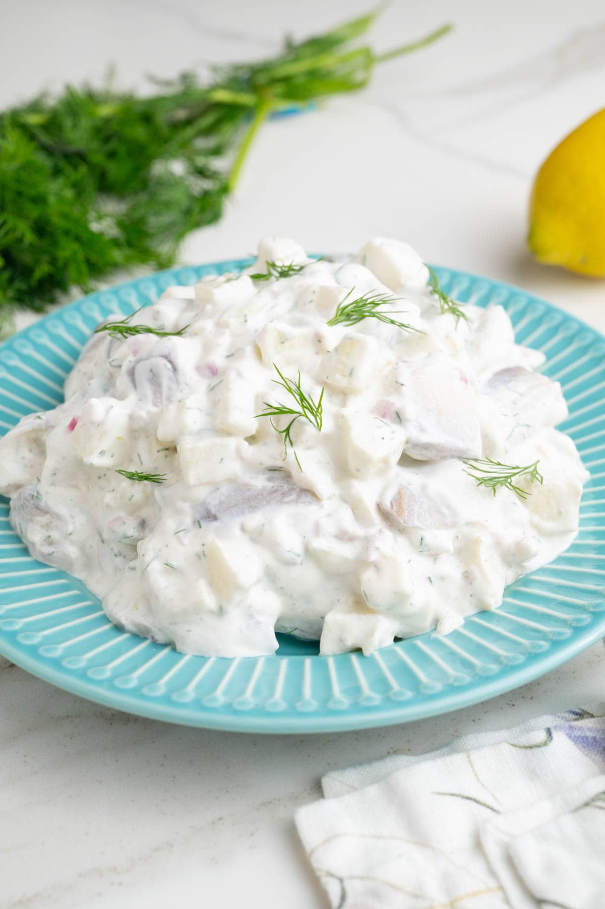 Herring in Cream Sauce on a blue plate.