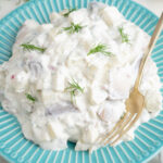 Herring in Cream Sauce on a blue plate.