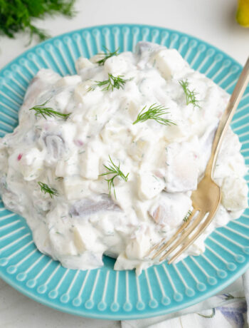 Herring in Cream Sauce on a blue plate.