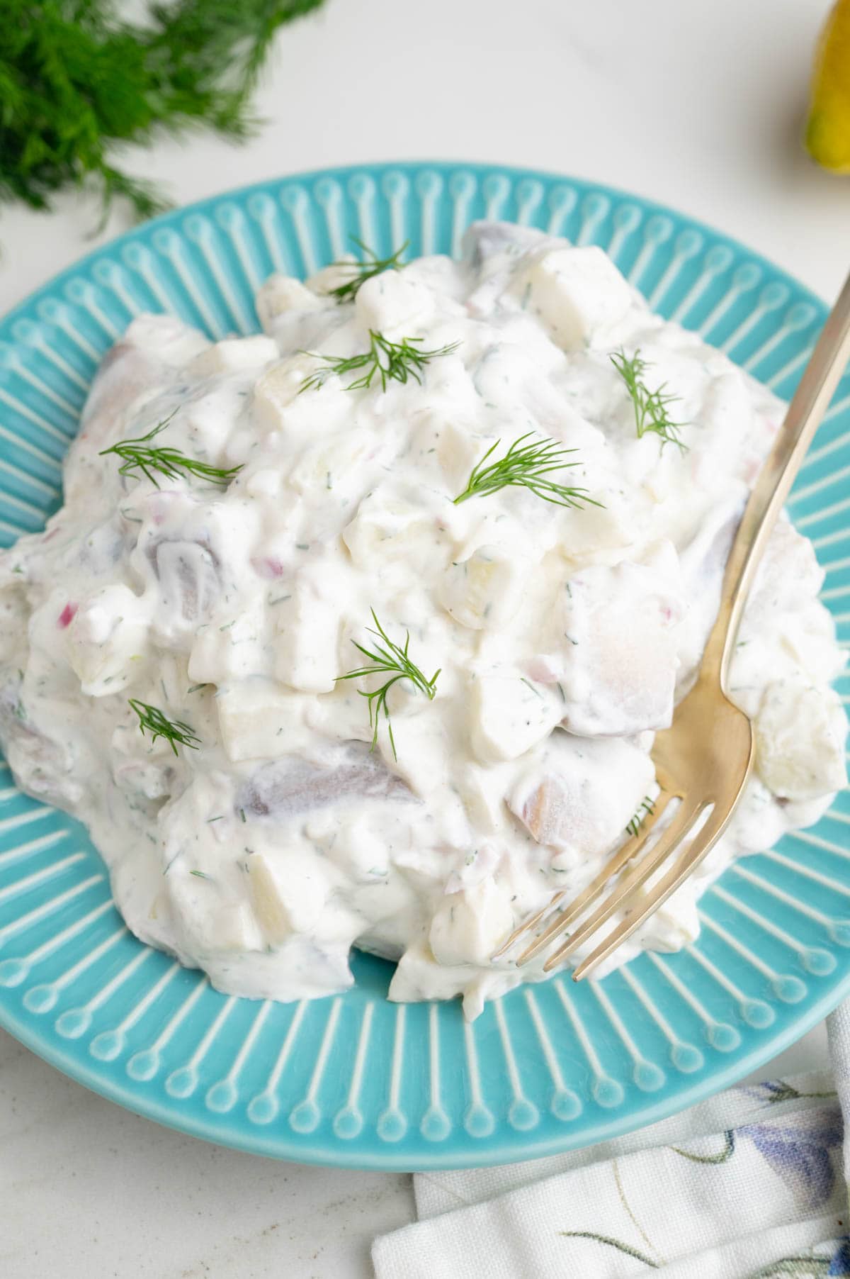 Herring in Cream Sauce on a blue plate.