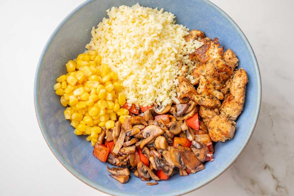 Ingredients for the chicken quesadilla filling in a blue bowl.