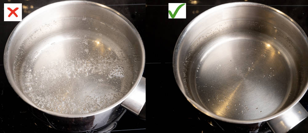 Two pots with water, one boiling rapidly and the other simmering gently.