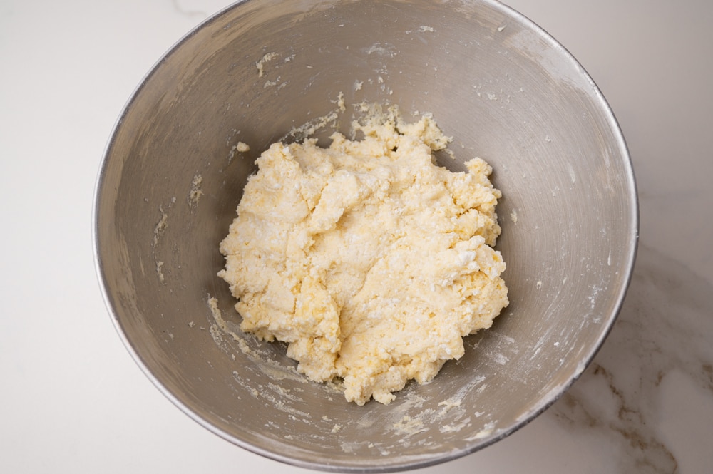 Oponki donuts dough in a metal bowl.