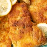 A close up photo of pan-fried carp fillets on a blue plate.