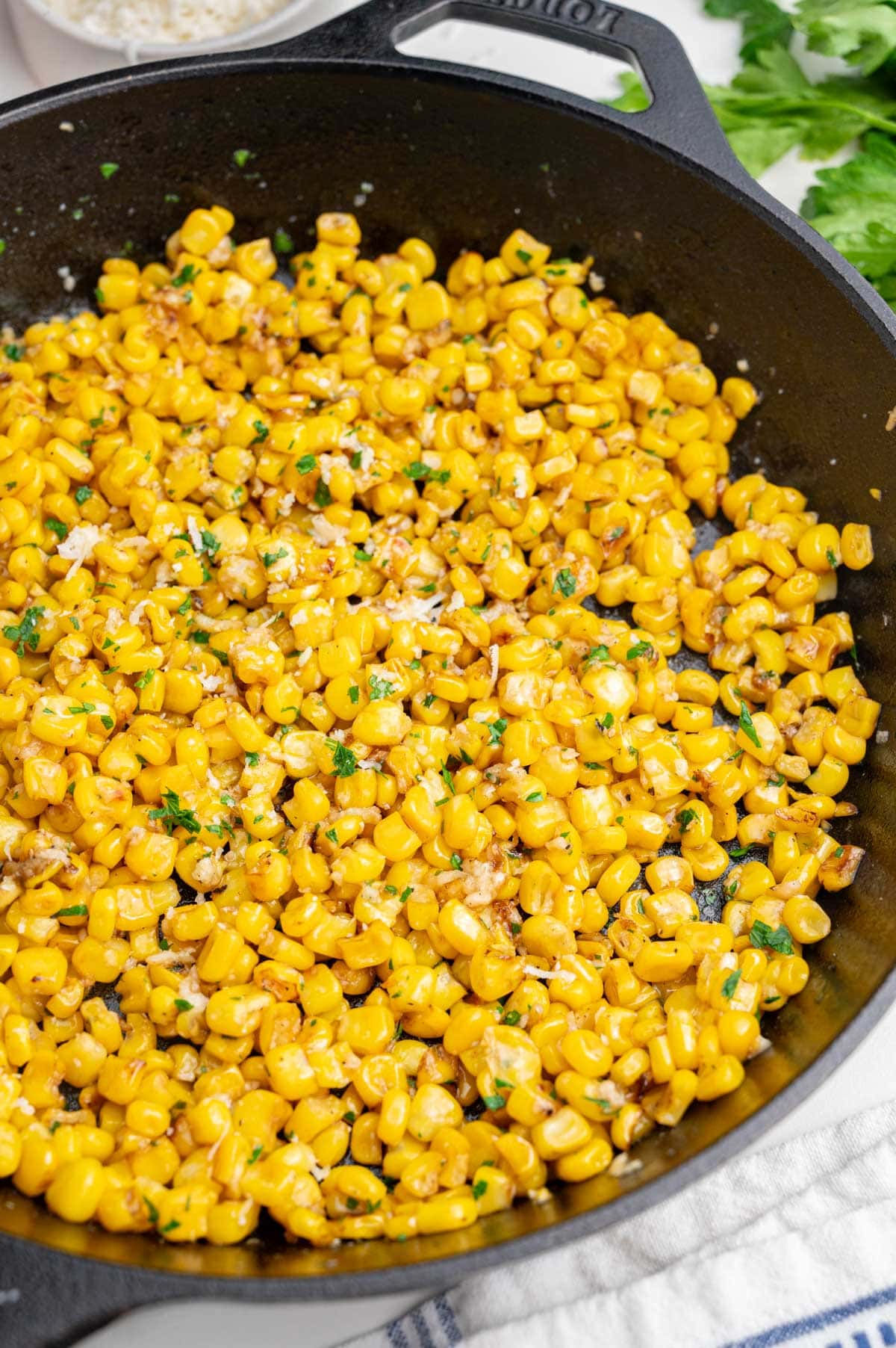 Sautéed corn in a black cast iron pan.