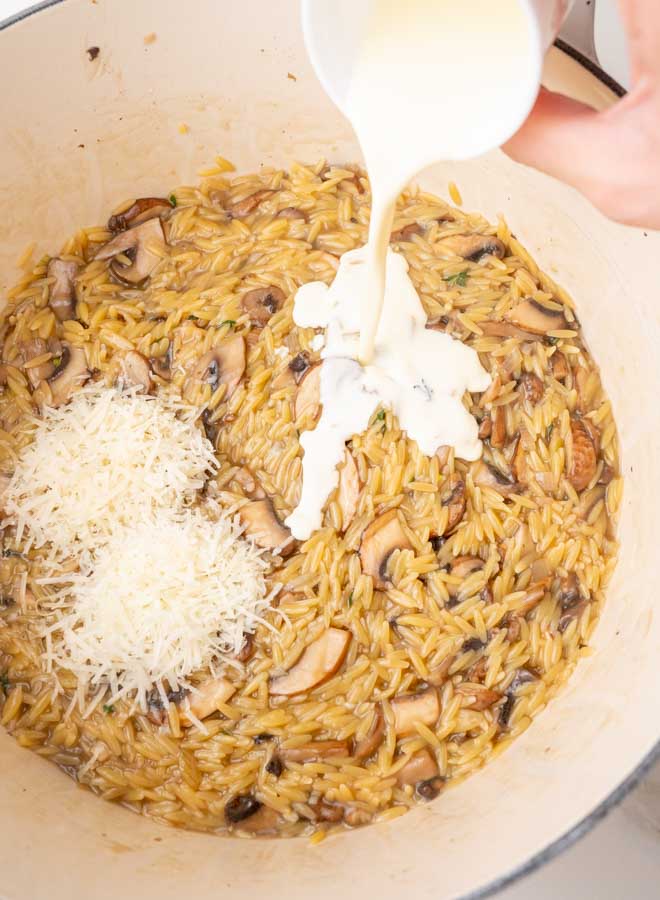 Cream and cheese are being added to mushroom orzo.