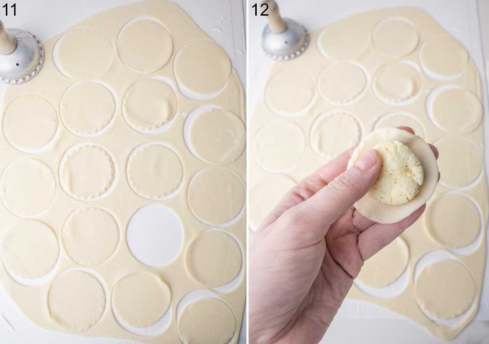 Rolled out pierogi dough with cut out rounds. Potato and cheese filling on a pierogi diugh round is being held in a hand.