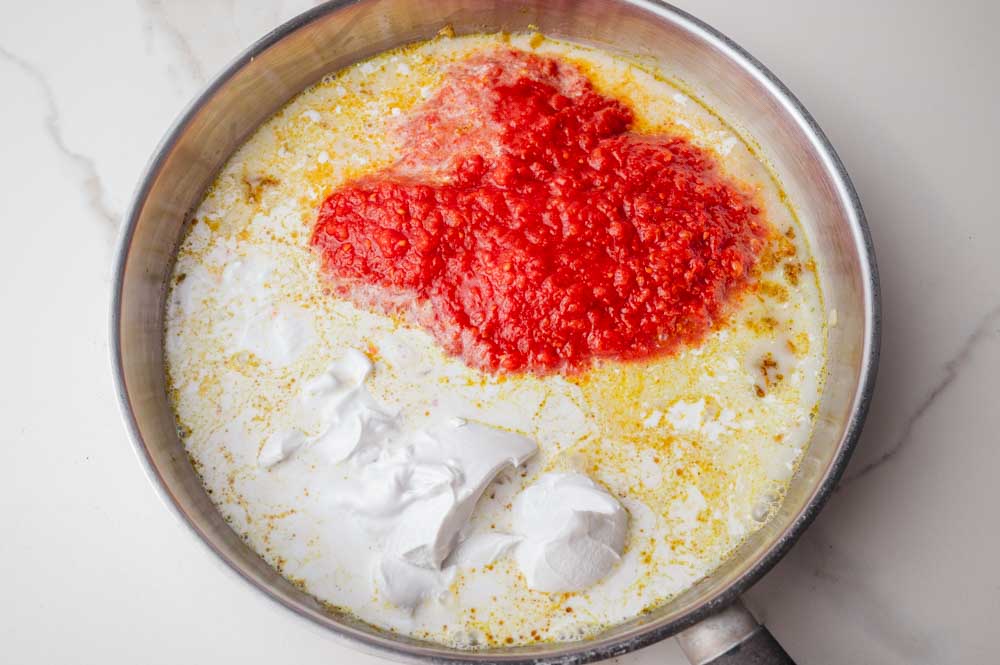 Ingredients for a curry sauce on a frying pan.