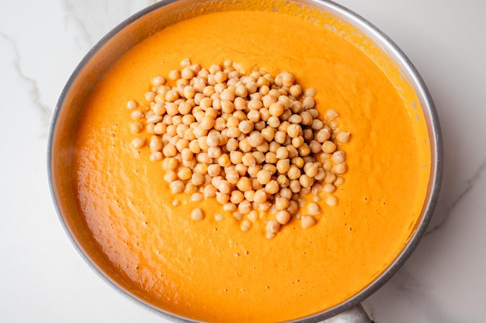 Curry sauce with chickpeas in a frying pan.