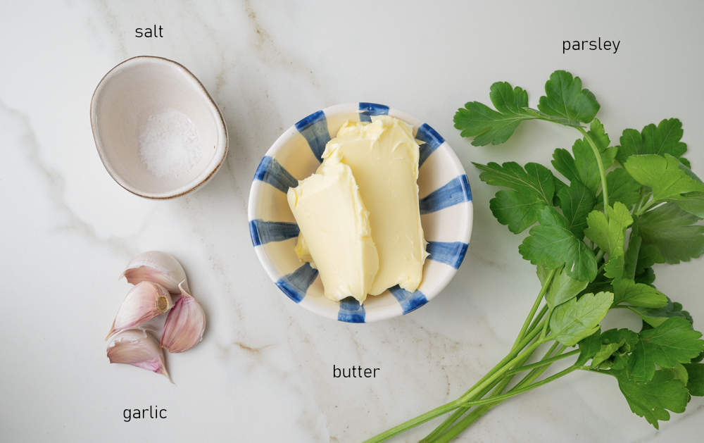 Labeled ingredients for garlic parsley butter.