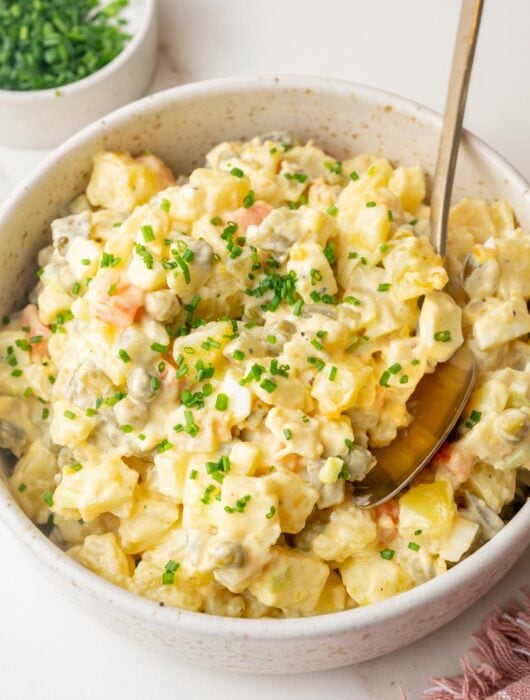 Polish salatka jarzynowa (vegetable salad) in a beige bowl.