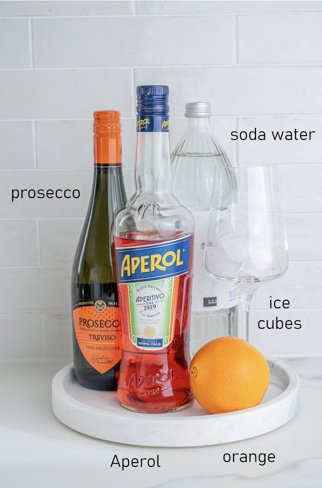 Labeled ingredients for Aperol Spritz cocktail.