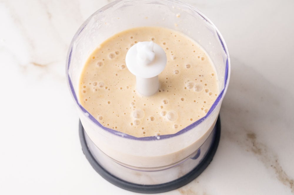 Mixed batter for the baked oats in a food processor container.