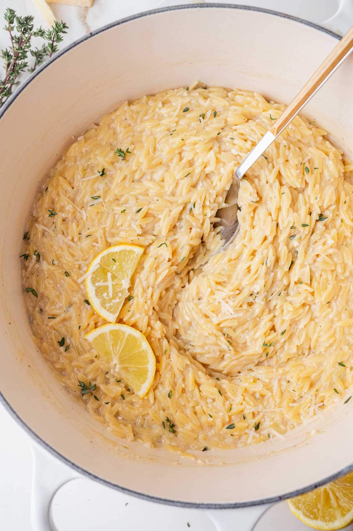 Creamy lemon parmesan orzo in a white pot.