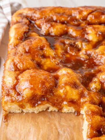 A close-up photo of Brunsviger cake on a wooden board.