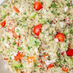 Couscous salad in a white bowl.